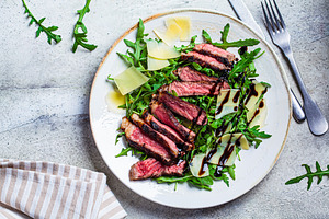 Beef steak tagliata with salad