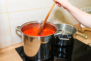 Cooking tomato sauce in big cooking pot, a Food & Drink Photo by Vapi