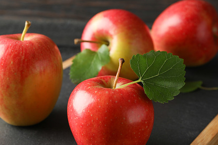 Apples and cutting board on wooden background, space for text, a Food & Drink Photo by AtlasStudio