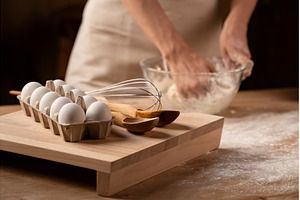 Hands kneading dough in a glass bowl, a Food & Drink Photo by volodymyrshtun13795