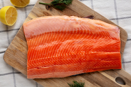 Organic Raw Salmon Fillet on a wooden board, top view. Flat lay,, a Food & Drink Photo by LiudmylaChuhunova