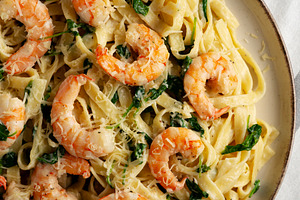 Homemade Creamy One-Pot Spinach Shrimp Pasta on a Plate, top vie, a Food & Drink Photo by LiudmylaChuhunova