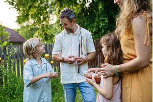 Girl rewarding boy with Easter eggs, a Holiday Photo by HalfPoint