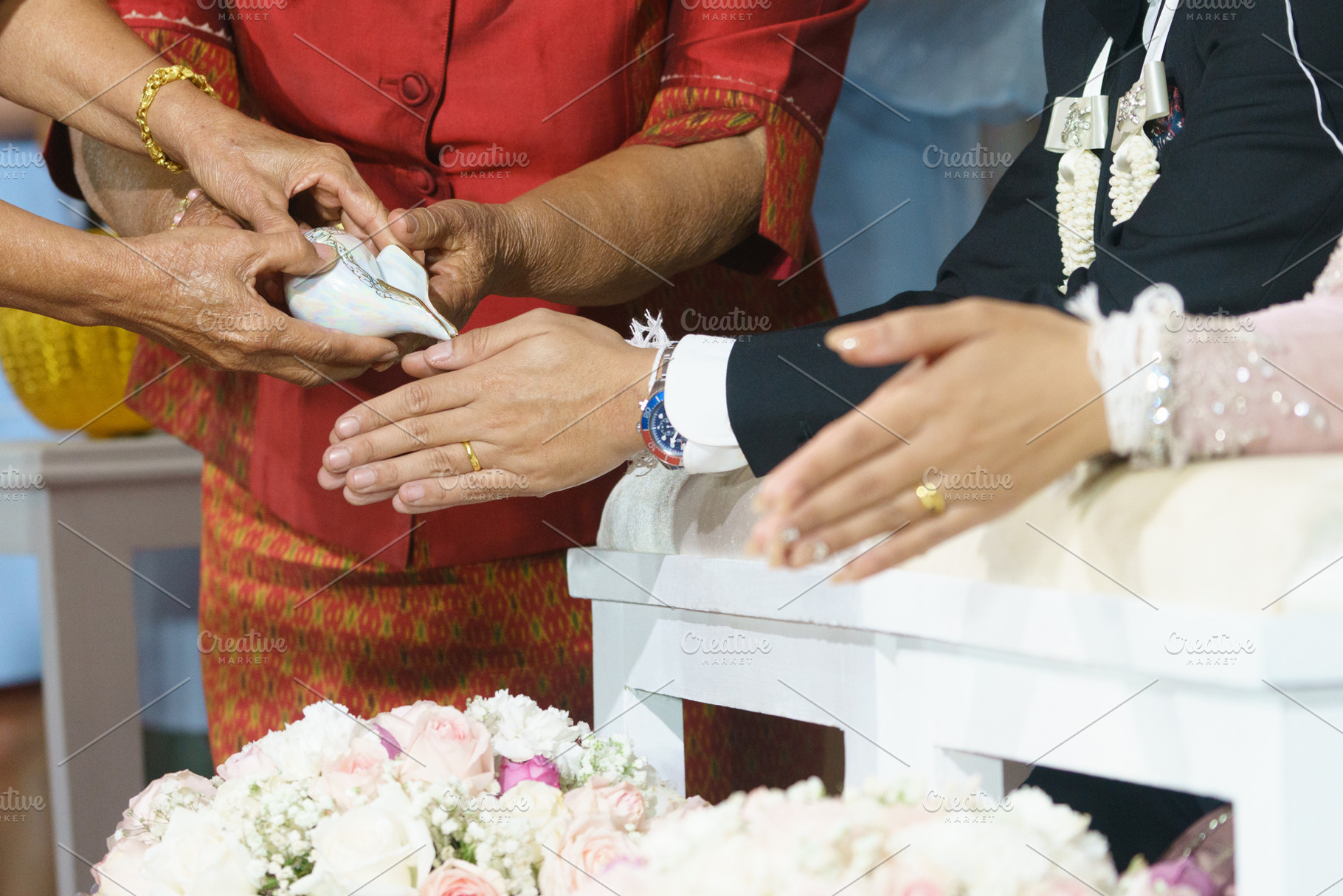 traditional wedding ceremony with hands exchanging rings and blessings, a Person Photo by a454