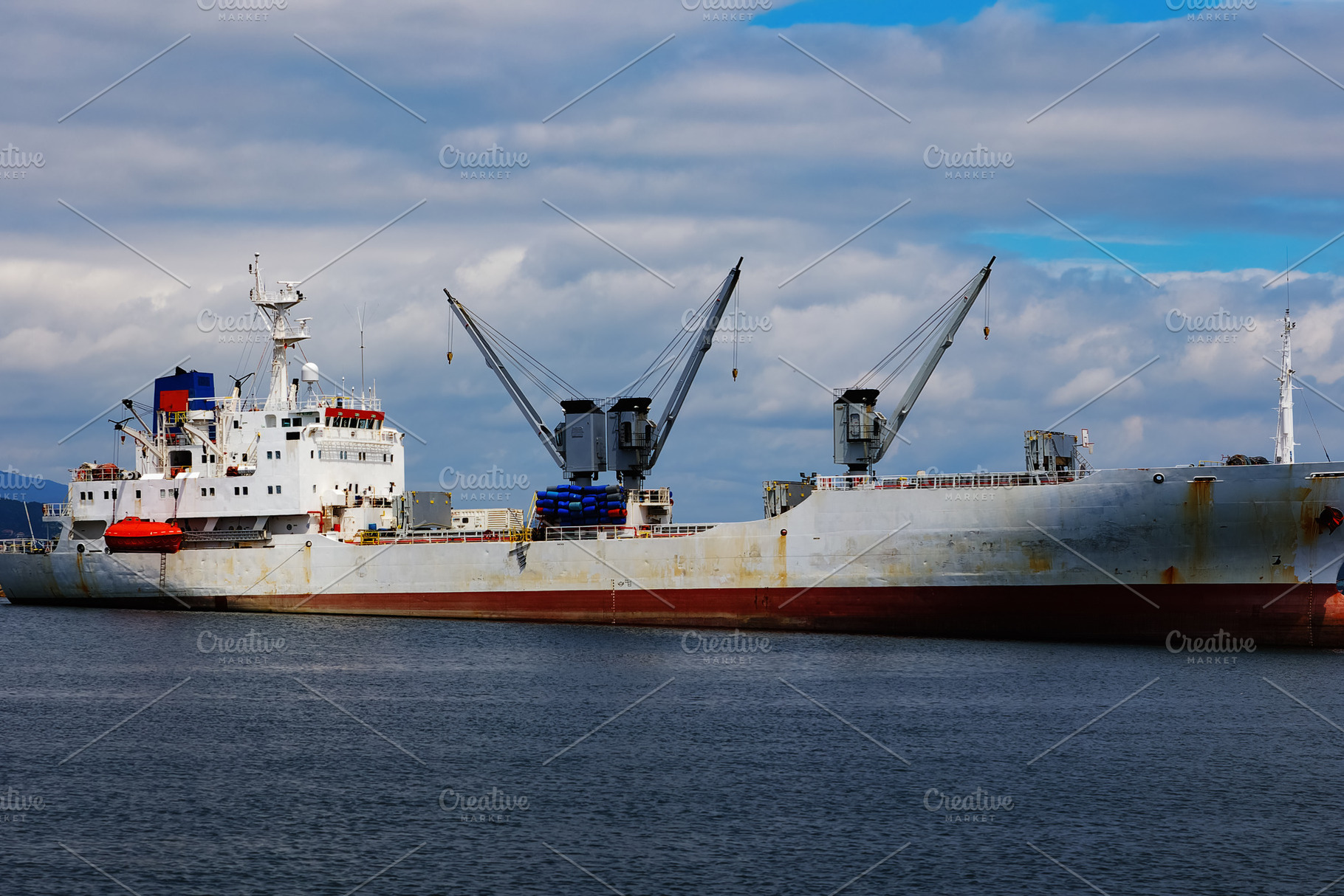 Industrial cargo ship docked in port, a Transportation Photo by Perpis