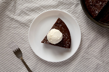 Homemade Chocolate Cake with Ice Cream on a white plate, top vie, a Food & Drink Photo by LiudmylaChuhunova