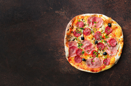 Homemade pizza top view with copy space on dark stone table featuring pizza, a Food & Drink Photo by Enjoy Photo