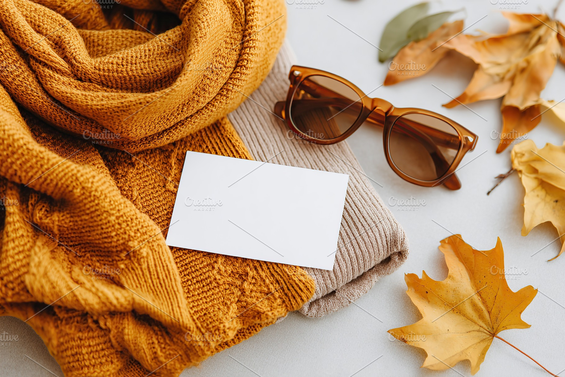 Vintage moodboard flat lay featuring a scarf, sunglasses, and autumn leaves, a Photo by AlyaAnd