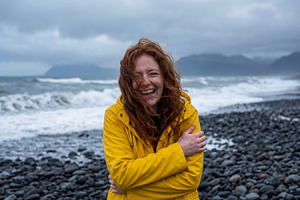 Joyful Redheaded Woman with Raincoat, a Person Photo by Virgo Studio