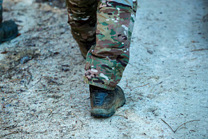 Soldier wearing camouflage pants and boots walking on a dirt road, a Sports & Recreation Photo by Antonio Gravante Market