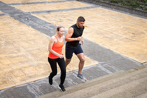 Athletic couple running up stairs during outdoor fitness workout, a Sports & Recreation Photo by etorres69