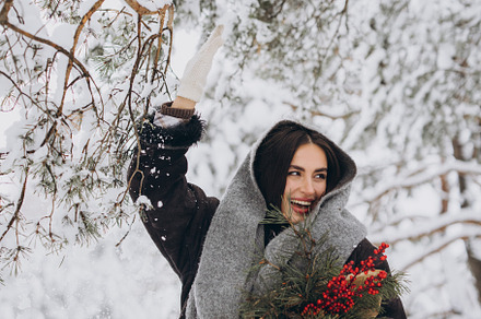 Happy woman holding winter bouquet, a Holiday Photo by Cherkas Photography