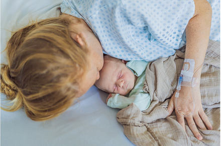 A baby lies with the mother after