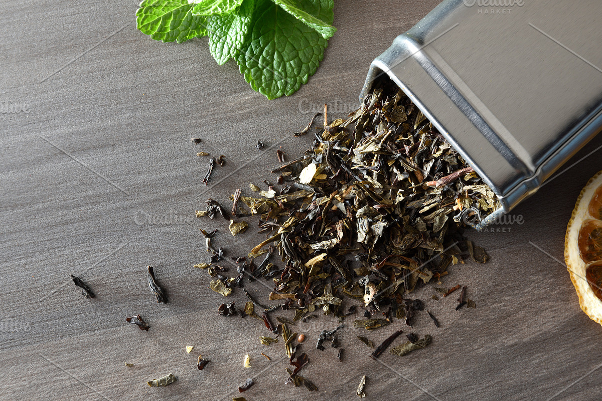 Wooden spoon filled with tea leaves on background of tea, a Food & Drink Photo by Davizro's Market (Photo 2 of 2)