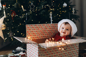 Merry Christmas and Happy Holidays! Cute baby in santa hat sitti, a Holiday Photo by Sonjachni