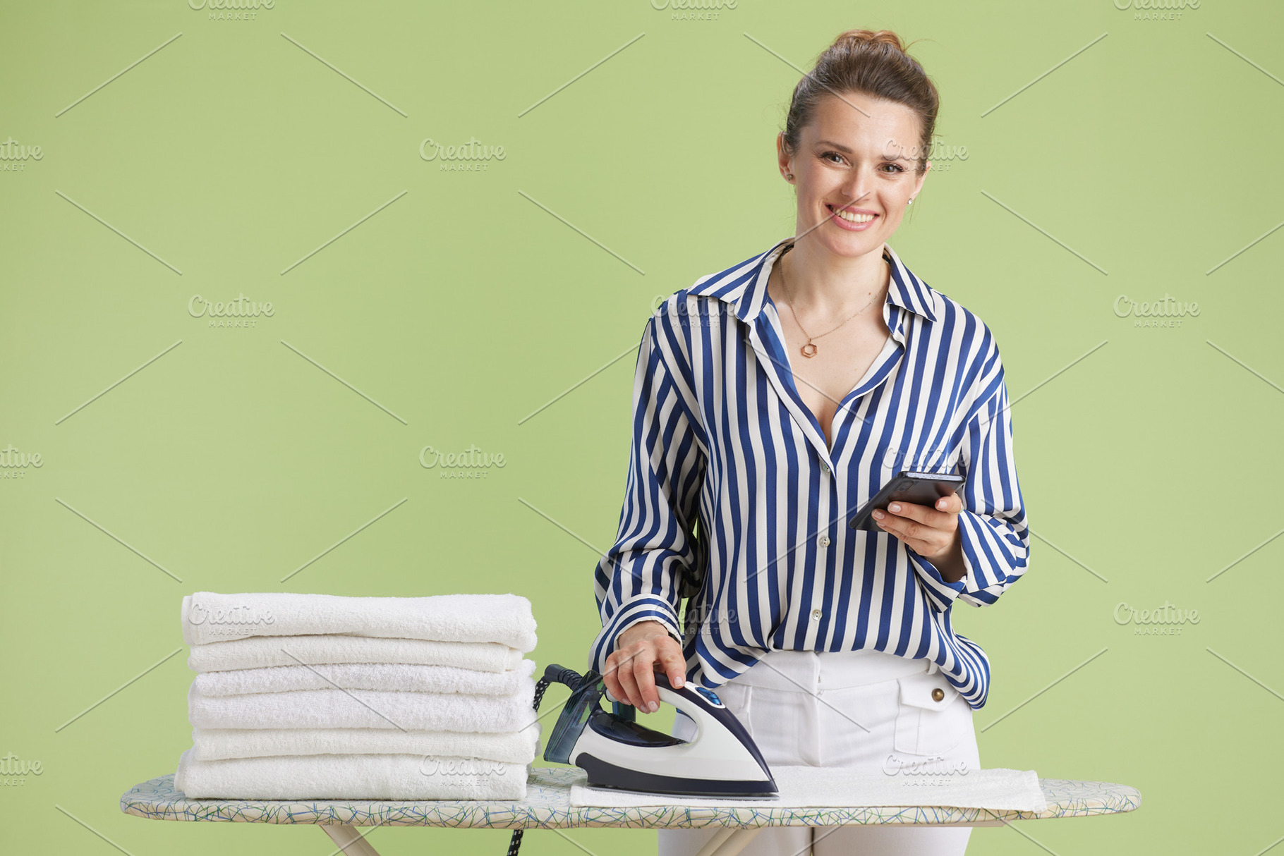 Multitasking: Ironing and tech, a Person Photo by Alliance Images