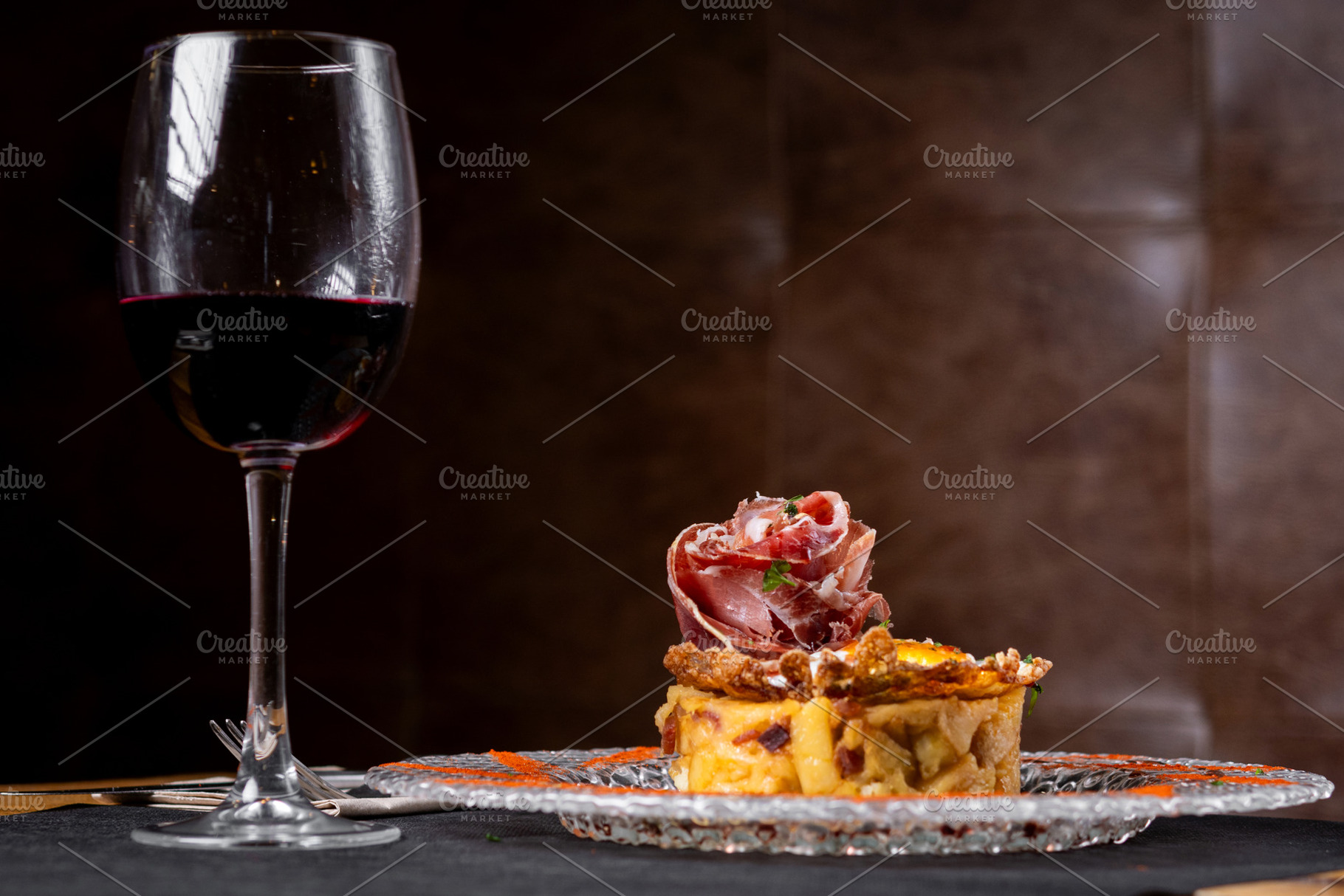 Vertical close up of Spanish potato omelette with Iberian ham and crispy pork r, a Food & Drink Photo by etorres69