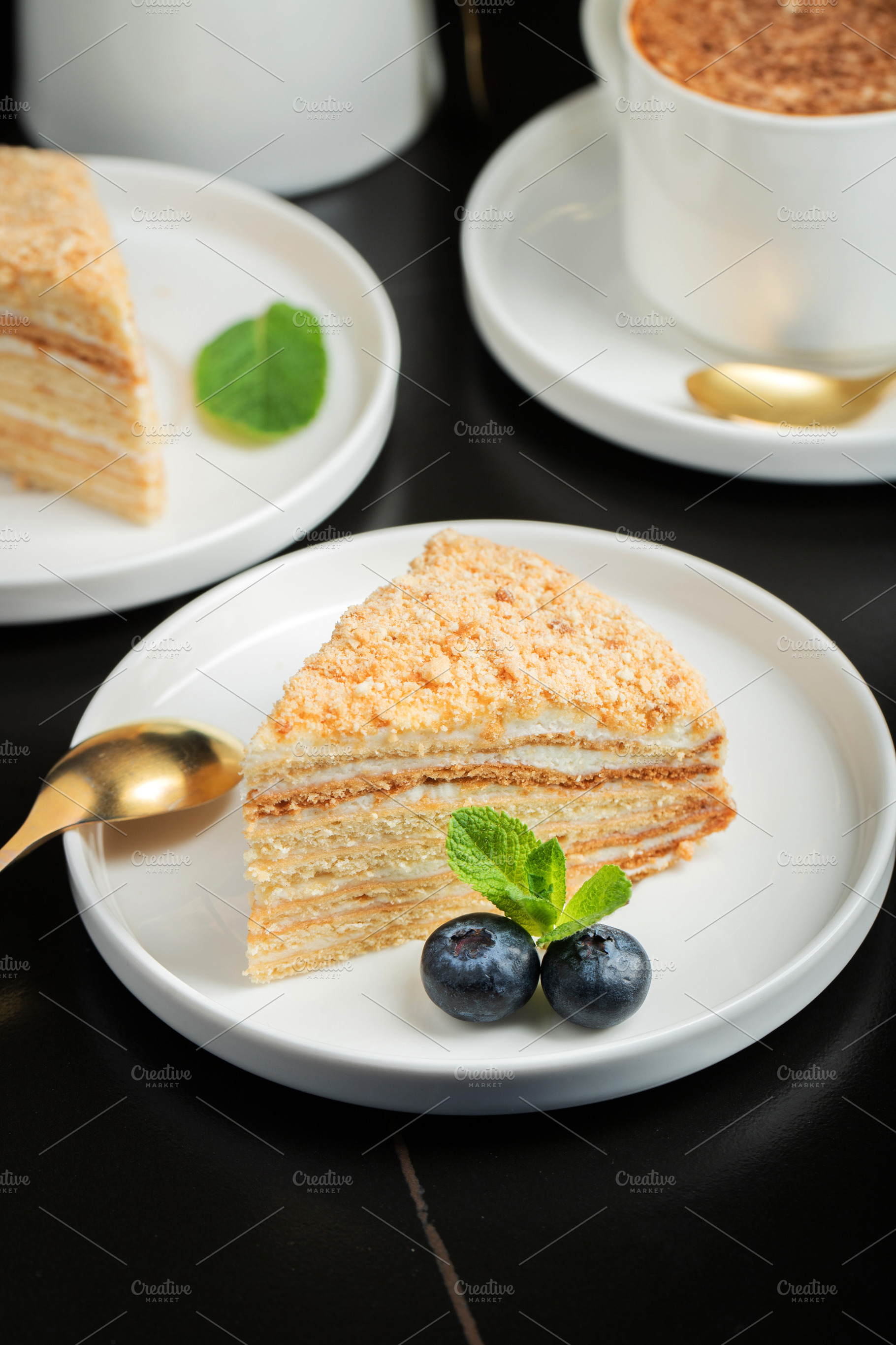 Medovik. Honey cake made from honey cakes with whipped sour cream, decorated wi, a Food & Drink Photo by Budarinphoto
