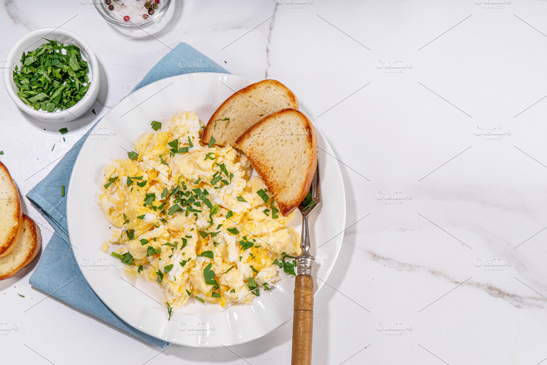 Traditional breakfast scrambled eggs with toasted bread, a Food & Drink Photo by Rimma