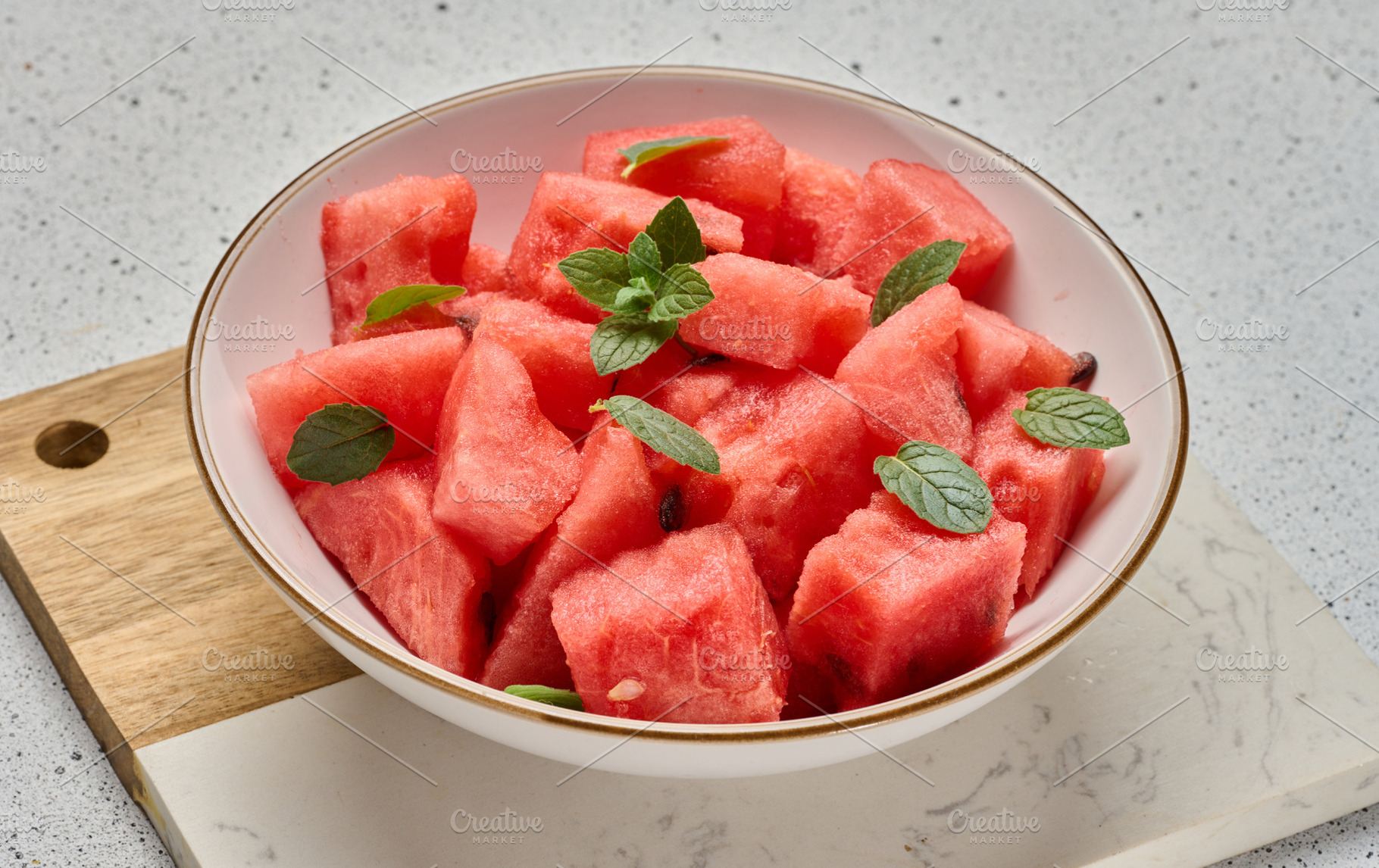 Ripe watermelon slices with mint leaves in a white round plate o, a Food & Drink Photo by ndanko