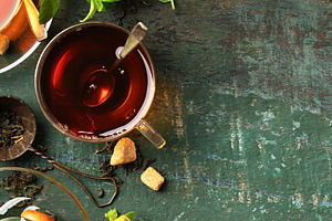 Herbal Tea with Lemon, Ginger, Mint, and Honey on Rustic Backgro