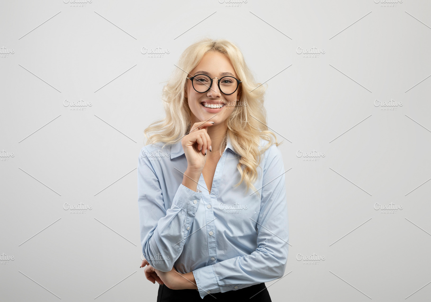 Female business career. Positive young businesswoman touching chin and smiling, a Photo by Prostock-Studio