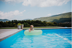 Little girl playing in shallow water, a Person Photo by HalfPoint