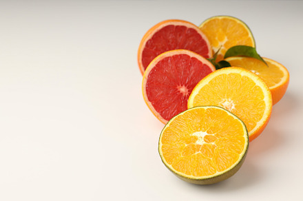 Citrus fruits on white background, space for text, a Food & Drink Photo by AtlasStudio PRO