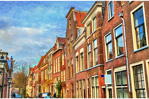 Traditional dutch houses on a street, an Architecture Photo by Leonid Andronov