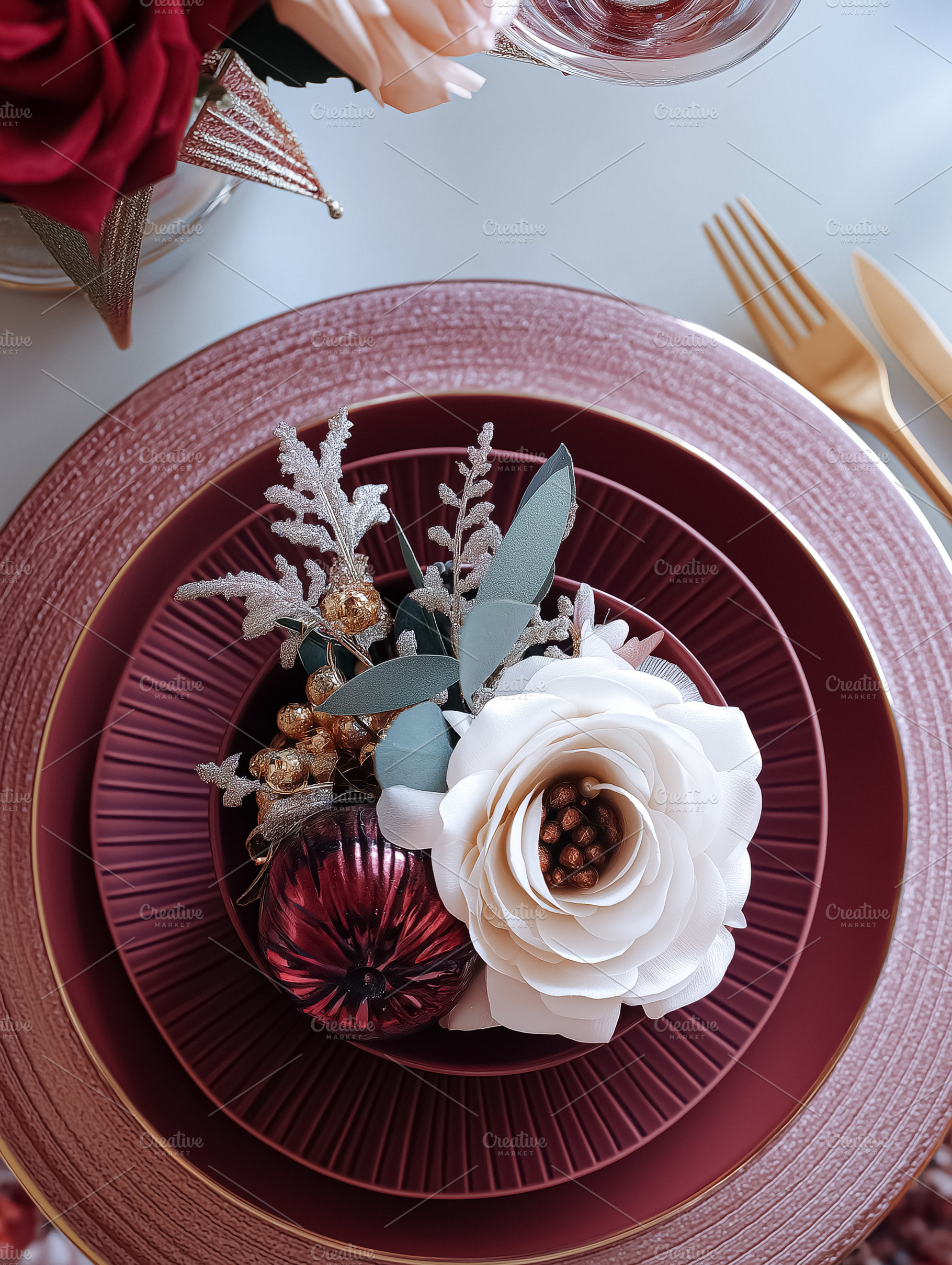 Festive Christmas dining table set with deep red plates, golden cutlery, and an, a Food & Drink Photo by Anneleven