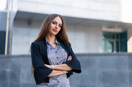 Business woman with long hair dressed black jacket standing outdoor near corpor, a Person Photo by andreonegin market