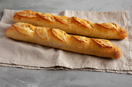 Homemade French Bread Baguette on a gray background, side view., a Food & Drink Photo by LiudmylaChuhunova