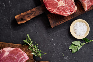 Various cuts of raw beef including rib-eye, roast beef, flank and rump steak di, a Food & Drink Photo by Asya Nurullina