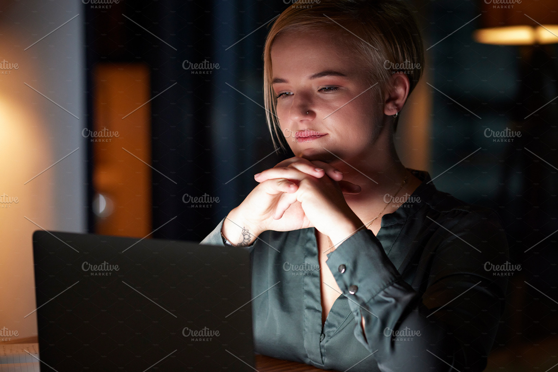 Night, laptop and thinking with woman in office for overtime, planning and strategy idea. Digital, technology and internet with employee and deadline at desk for goals, management solution and email, a Photo by Peopleimages.com
