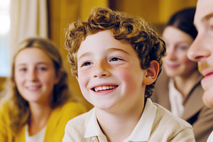 Child smiling among family during ho, a Photo by Dvoevnore photos