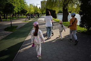 Family on a walk near a lake in a park on a sunny day, a Person Photo by AS photostudio