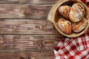 Flat lay of freshly different baked bread in basket with napkin on wooden table, a Food & Drink Photo by AlyaAnd