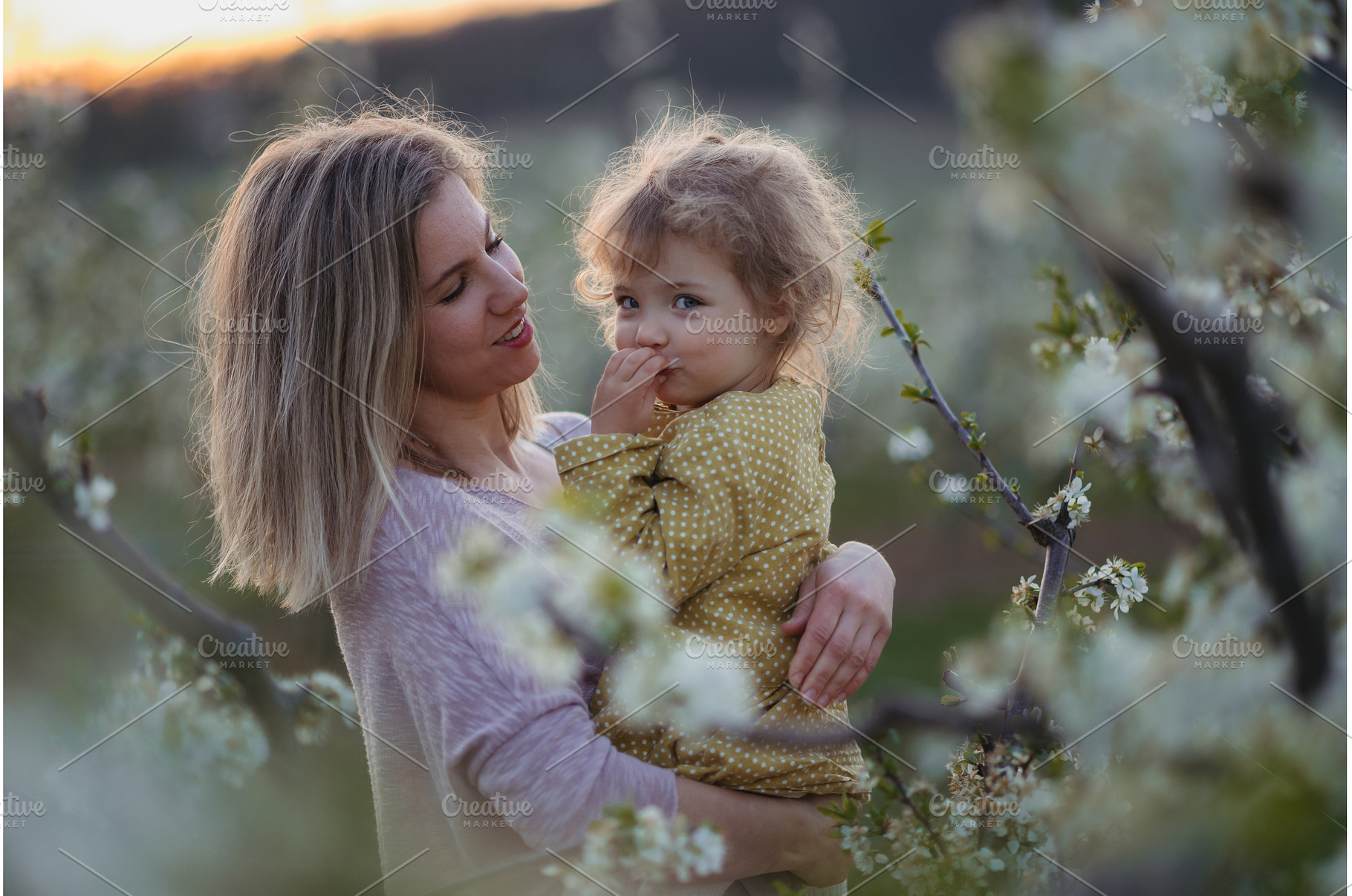 Girl with mom in middle of blooming, a Person Photo by HalfPoint
