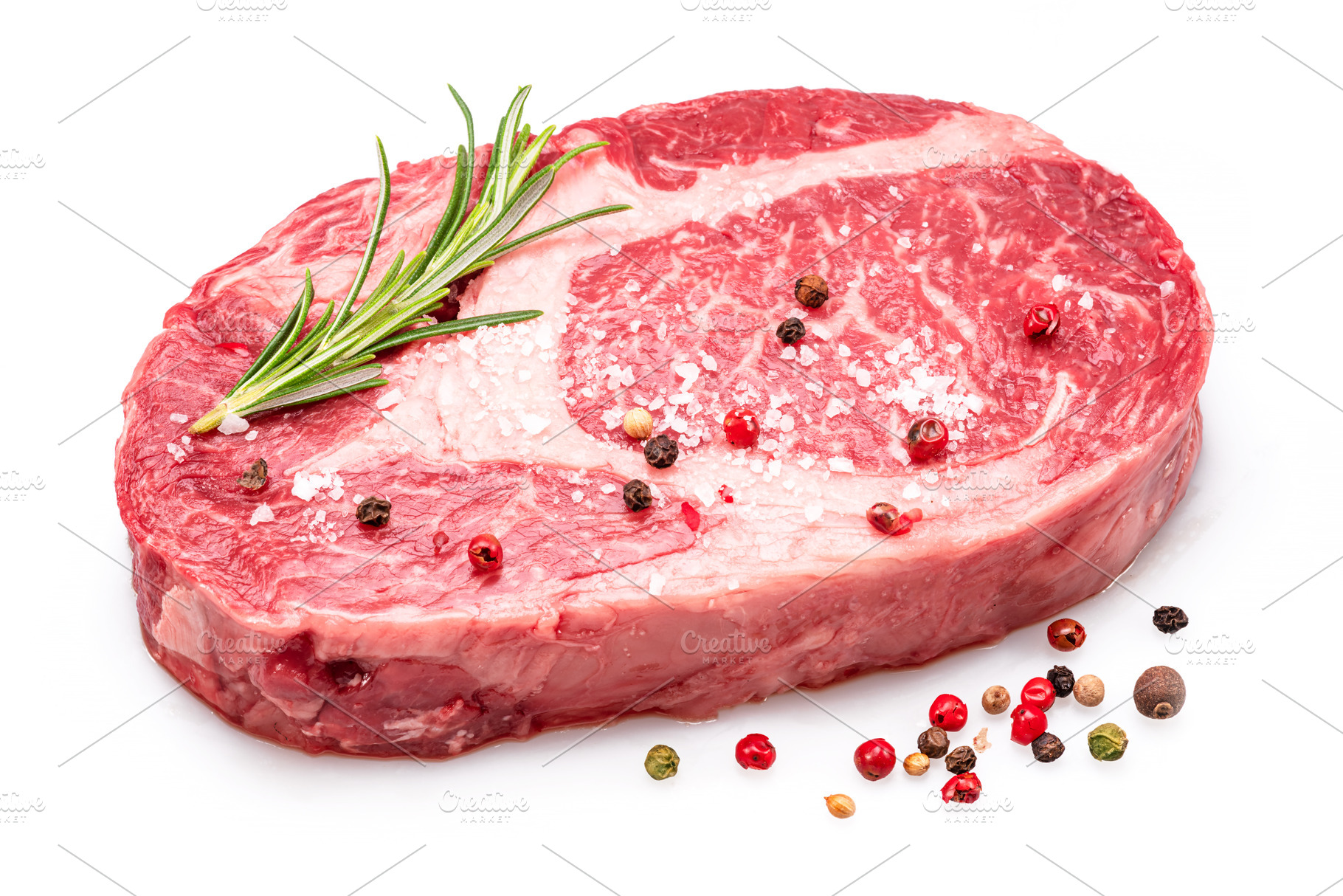 Raw ribeye steak with pepper corns, a Food & Drink Photo by Volff