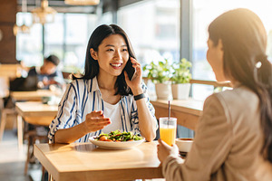 Women enjoying lunch and conversation in cafe, a Person Photo by DanFLCreativo