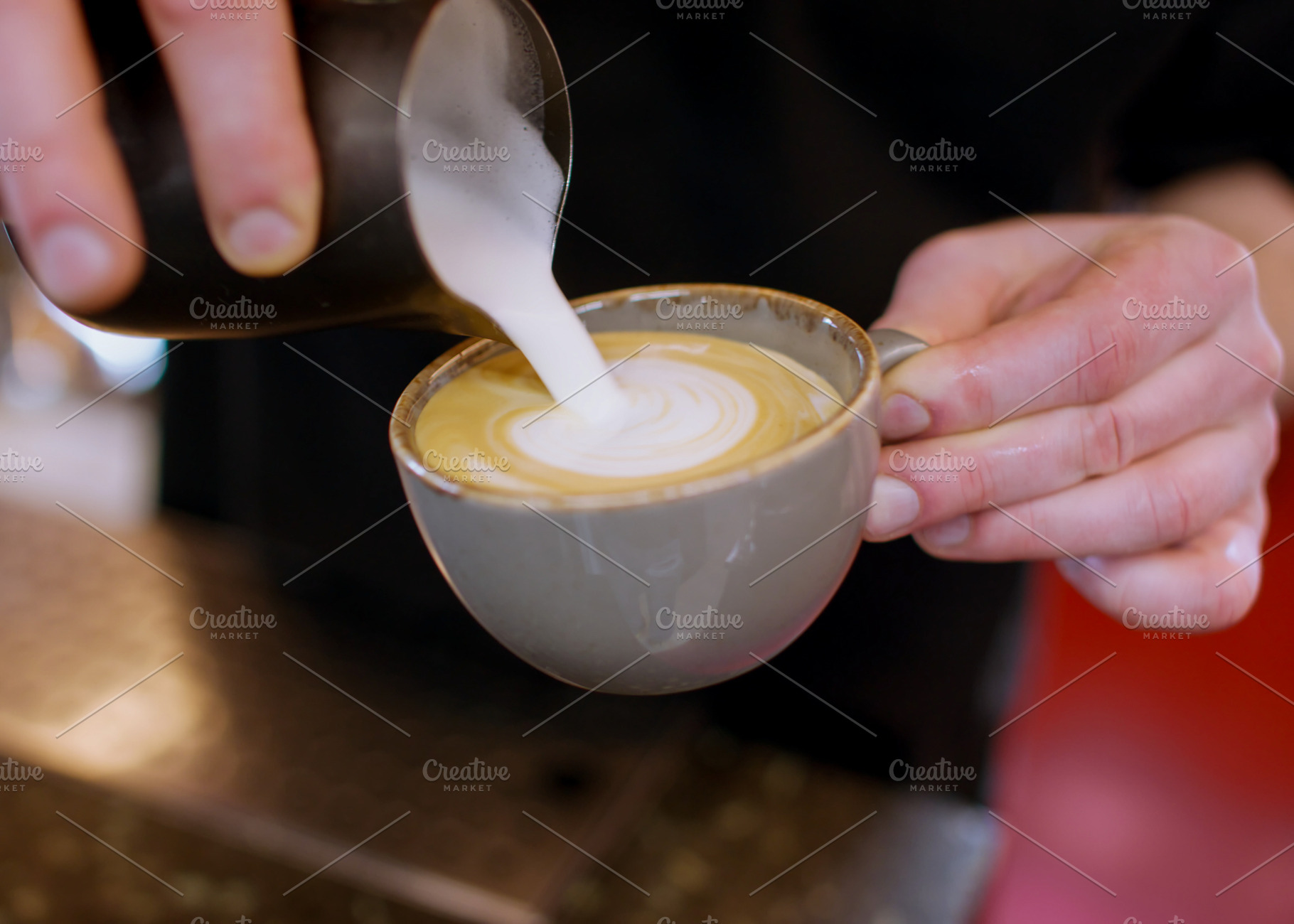 Latte art pouring foamed milk barista hand cup, a Person Photo by Photo Drive Studio