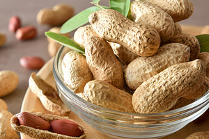 Macro view of group of peanuts in bowl on table, a Food & Drink Photo by Davizro's Market