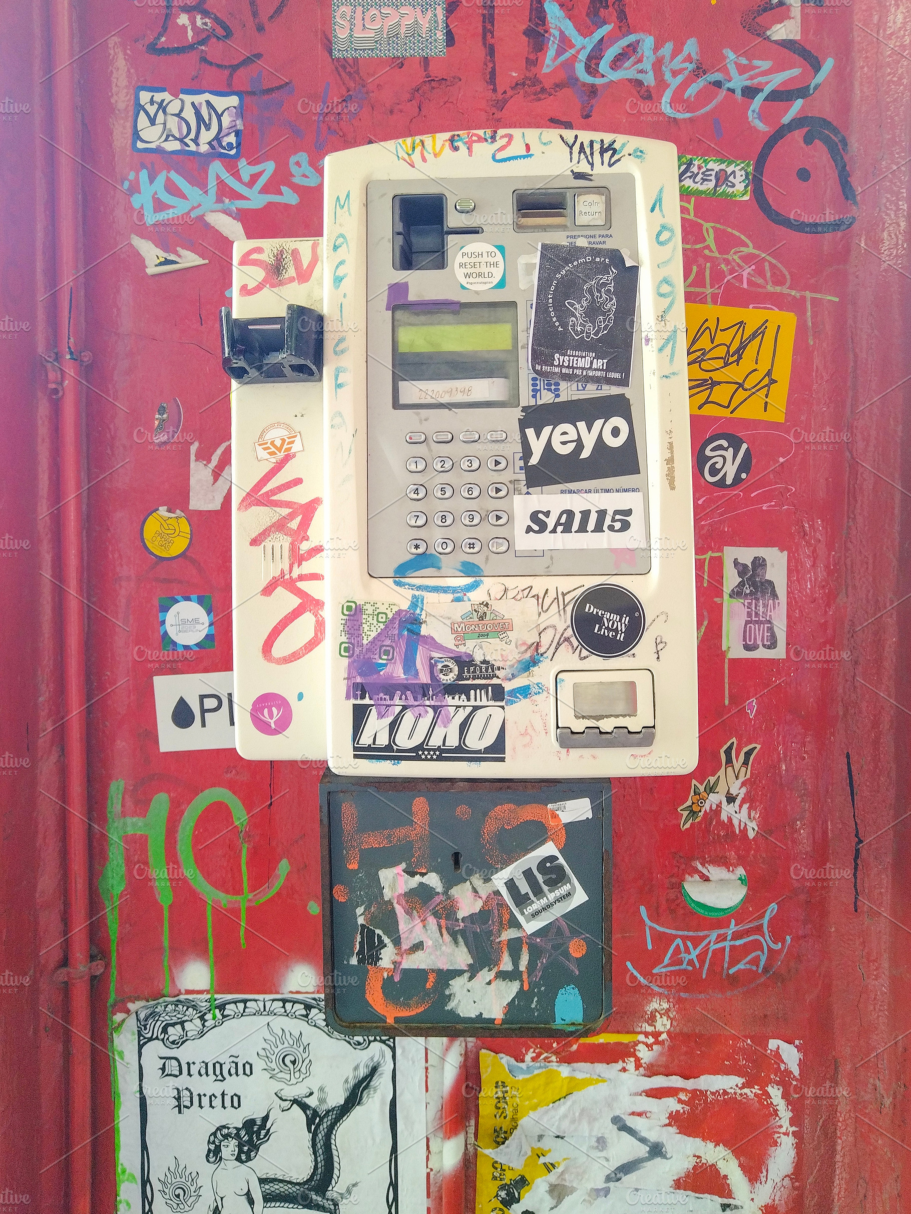 Sticker-covered vending machine on graffiti wall, an Arts & Entertainment Photo by DanFLCreativo