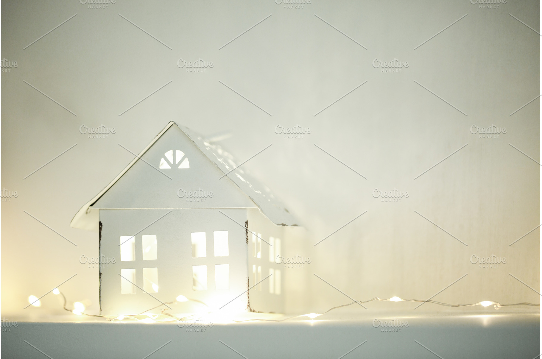 White miniature house illuminating a, a Holiday Photo by Anna Efetova