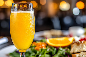 Refreshing mimosa with orange slice, a Food & Drink Photo by Lermont51