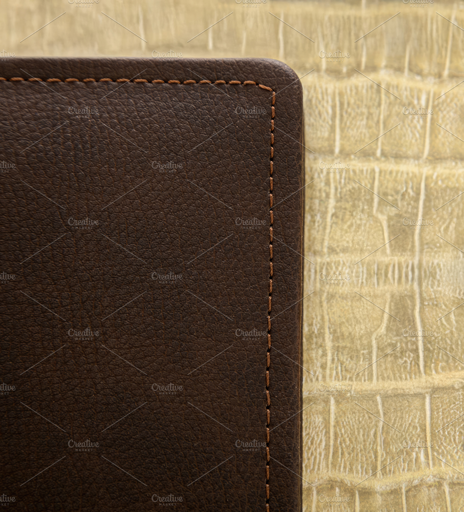 Detail of brown leather cover with stitching on textured background, an Abstract Photo by Antonio Gravante Market