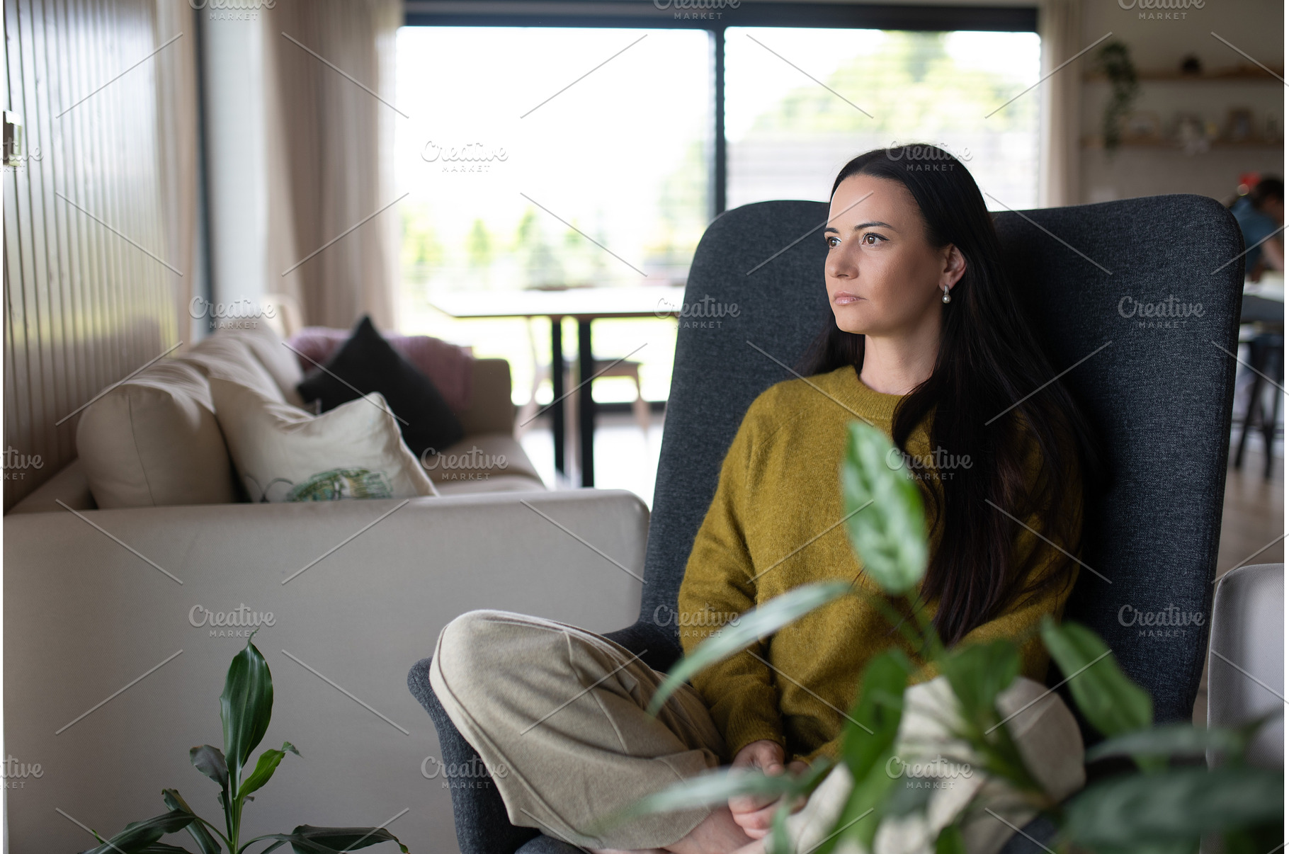 Depressed woman sitting in armchair, a Person Photo by HalfPoint