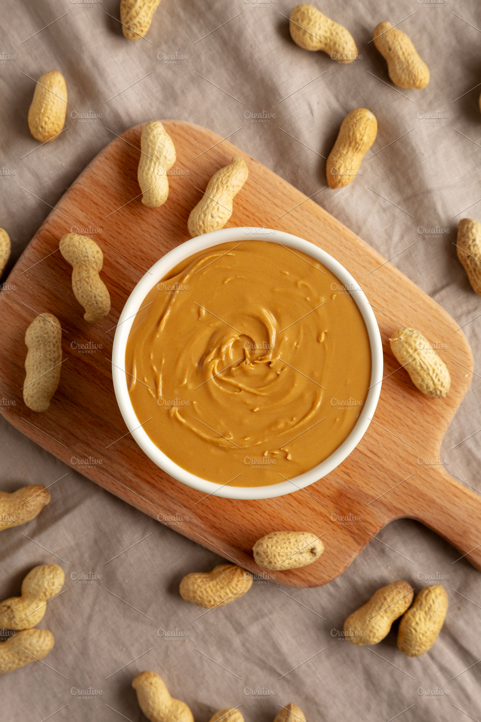 Organic Peanut Butter in a Bowl, top view. Flat lay, overhead., a Food & Drink Photo by LiudmylaChuhunova