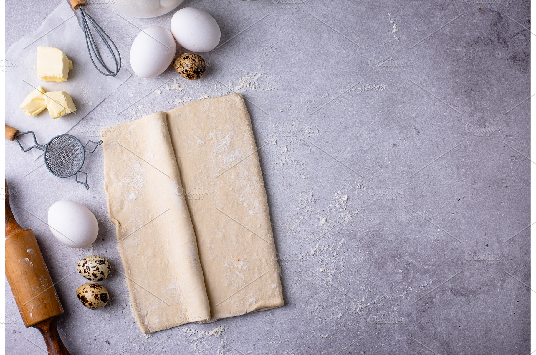 Raw puff pastry dough with baking, a Food & Drink Photo by Yulia Furman