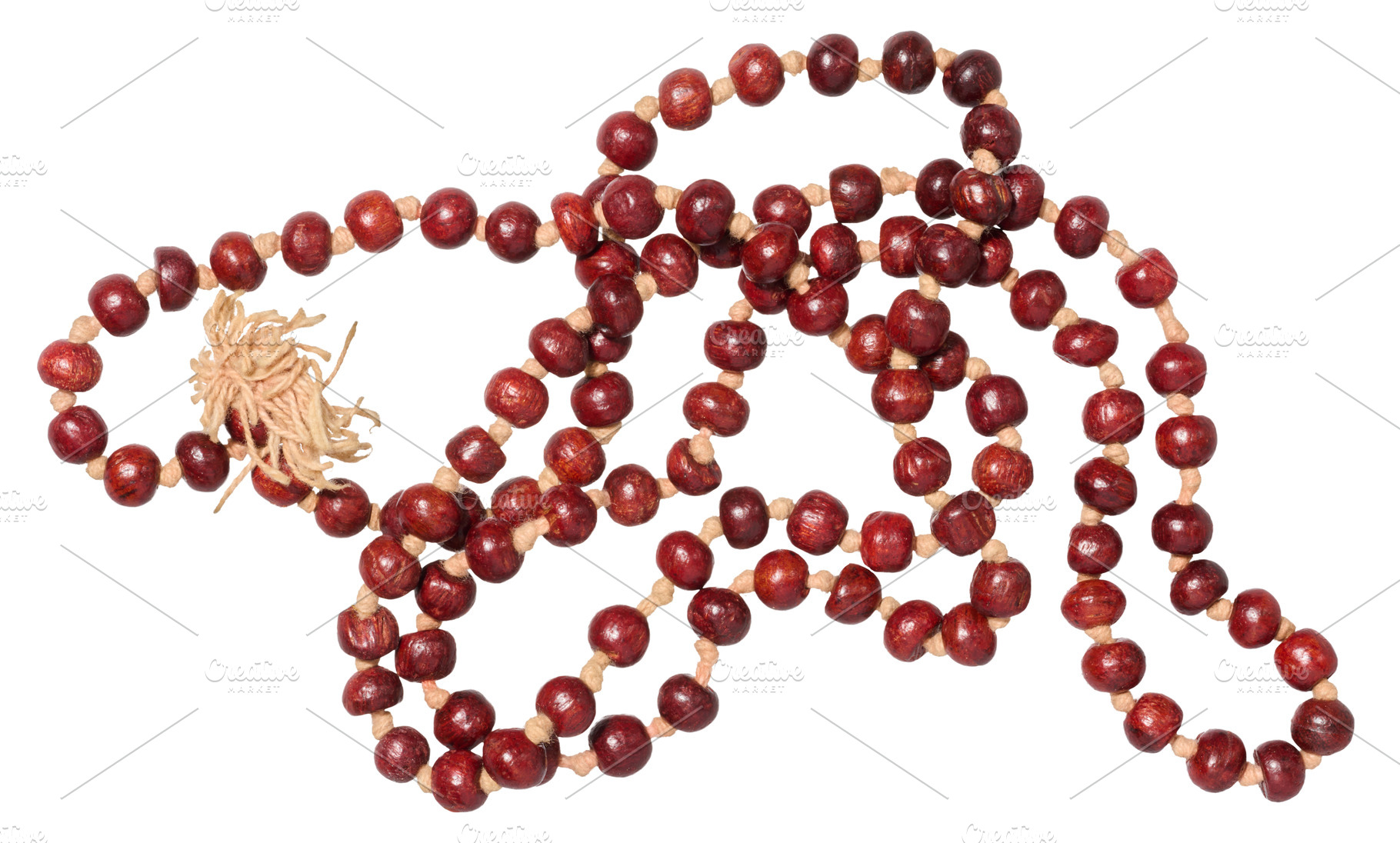 A string of red beads, made from sandalwood, with a light tassel, an Abstract Photo by ndanko